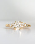 Gold ring with a diamond on a light gray background