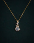 Gold necklace with a diamond pendant on a dark background