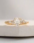 Gold ring with a diamond on a marble surface