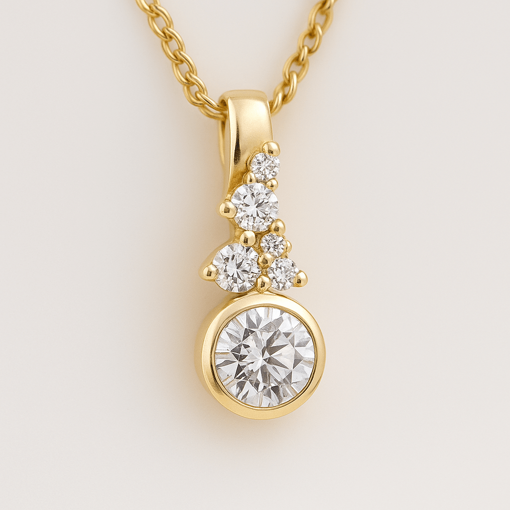 Gold necklace with a diamond pendant on a light beige background