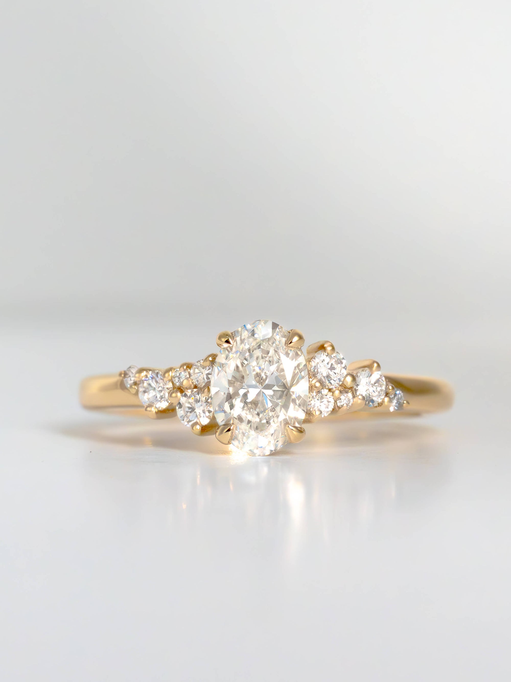 Gold ring with a diamond on a light gray background