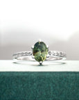 Ring with a green gemstone on a textured surface