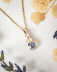 Gold necklace with a diamond pendant on a soft background