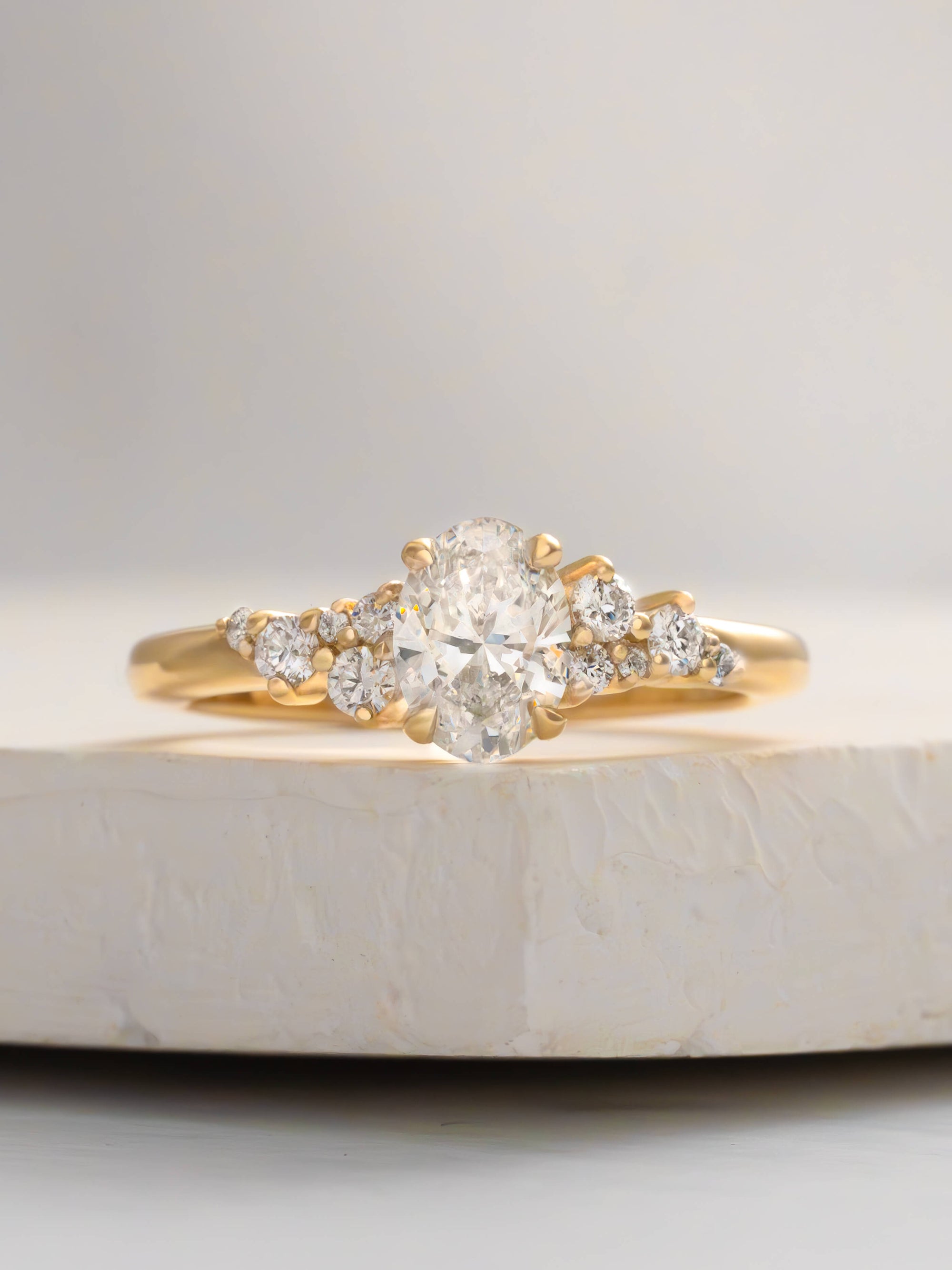 Gold ring with a diamond on a marble surface